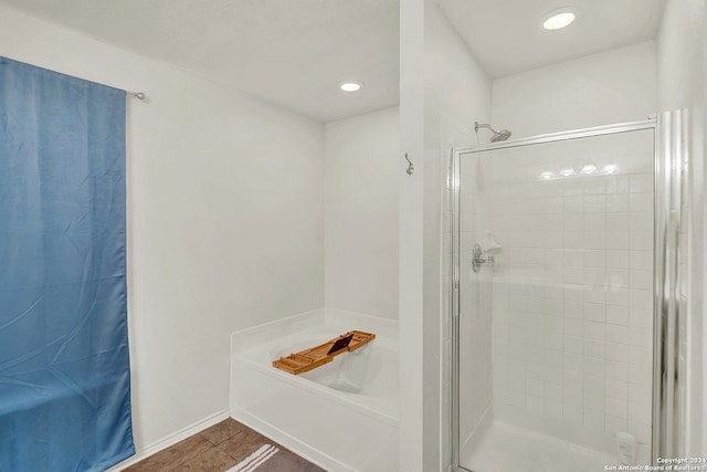 bathroom featuring tile patterned floors and separate shower and tub