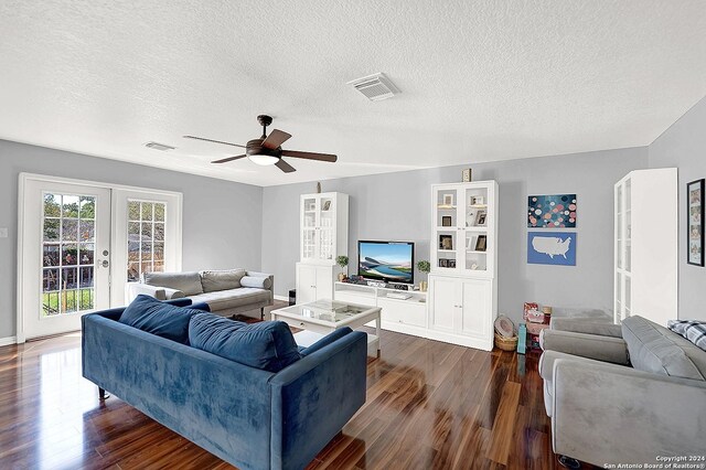 living room with a textured ceiling, ceiling fan, french doors, and dark hardwood / wood-style floors