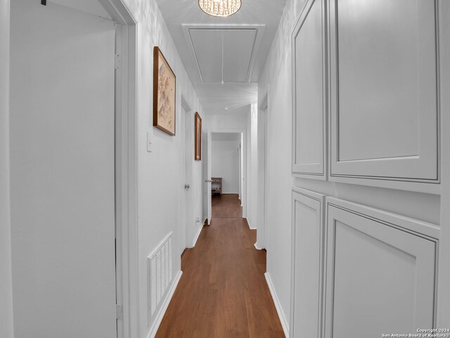 hallway featuring light tile patterned floors, sink, and an inviting chandelier