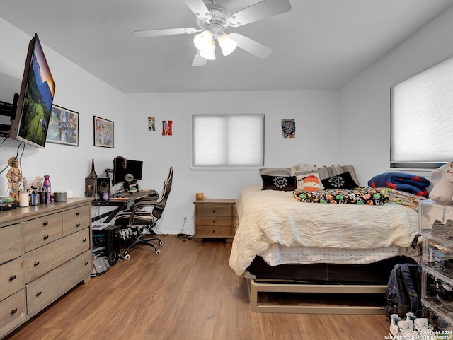 bedroom with ceiling fan and light hardwood / wood-style flooring