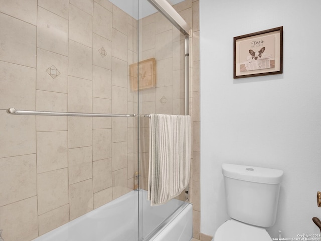 bathroom with toilet and enclosed tub / shower combo