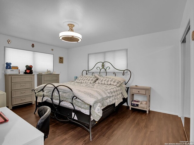 bedroom with light hardwood / wood-style floors and a closet