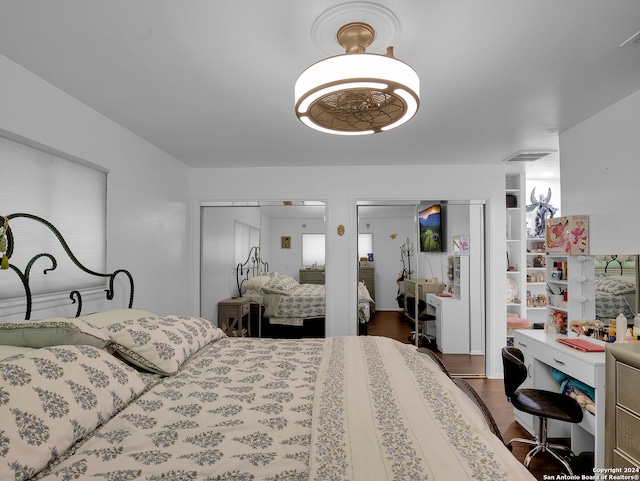 bedroom with dark wood-type flooring