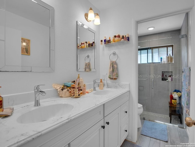 bathroom with vanity, toilet, and an enclosed shower