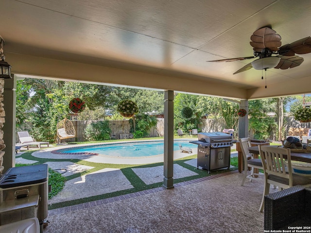 view of pool with ceiling fan, a patio area, and grilling area