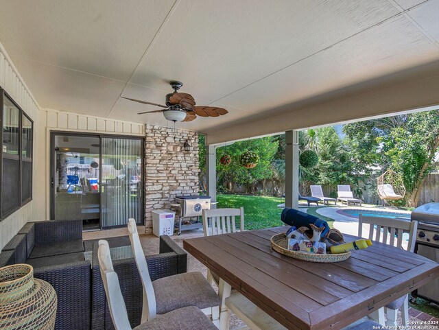 view of swimming pool with ceiling fan, area for grilling, and a patio