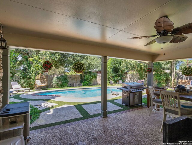 view of swimming pool with area for grilling, a yard, and a patio