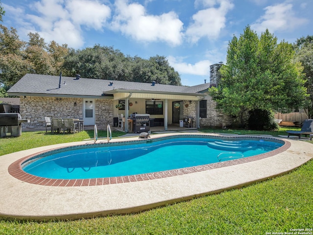 view of swimming pool with a grill, ceiling fan, and a patio