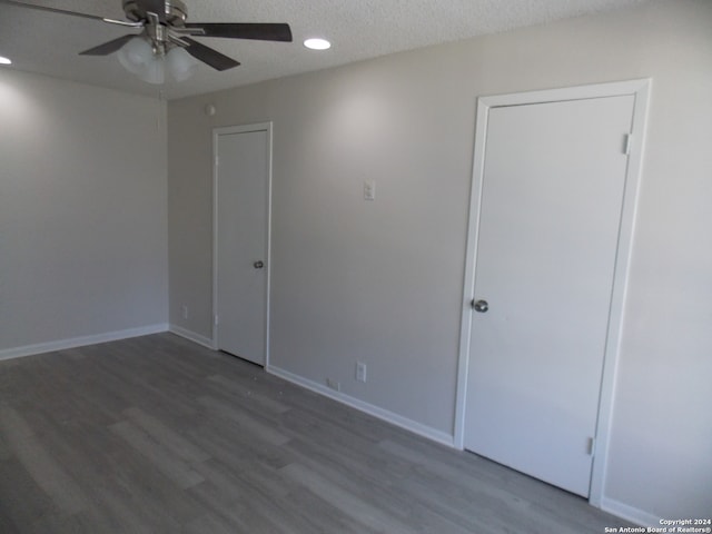 unfurnished room with a textured ceiling, ceiling fan, and hardwood / wood-style floors