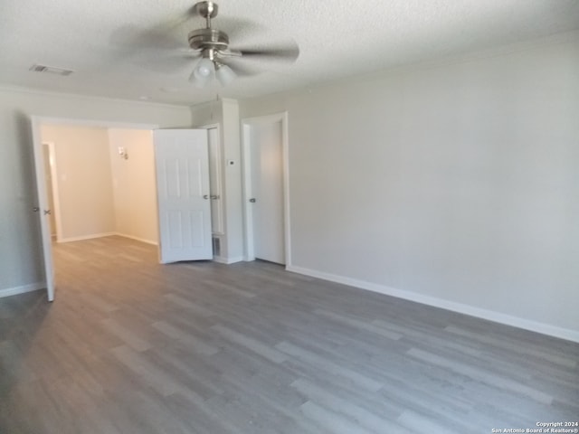 unfurnished bedroom with a textured ceiling, hardwood / wood-style flooring, and ceiling fan