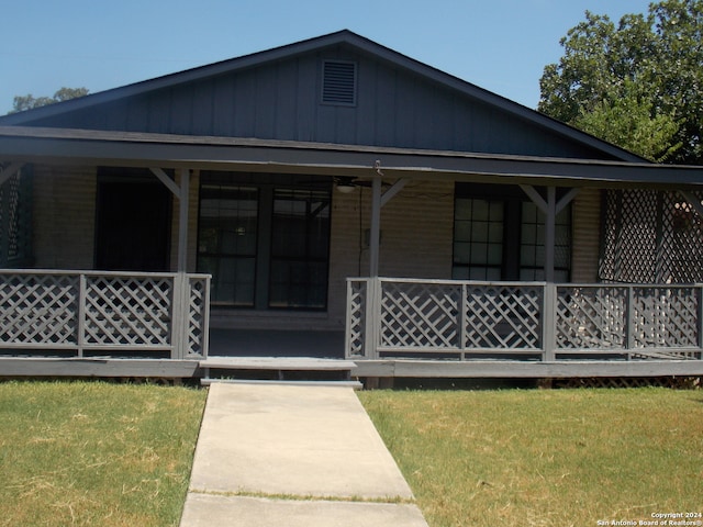 view of front of home featuring covered porch and a front yard