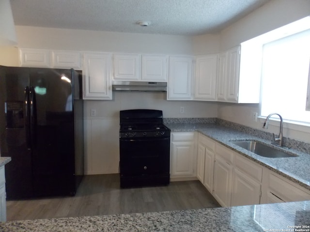 kitchen with a textured ceiling, black appliances, wood-type flooring, sink, and white cabinets