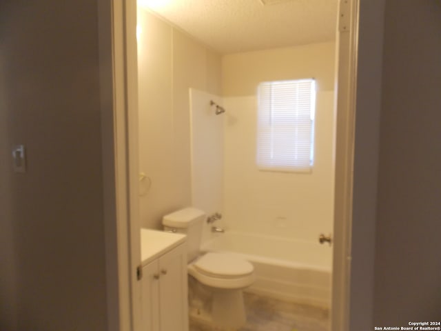 full bathroom with a textured ceiling, vanity, toilet, and shower / bathing tub combination