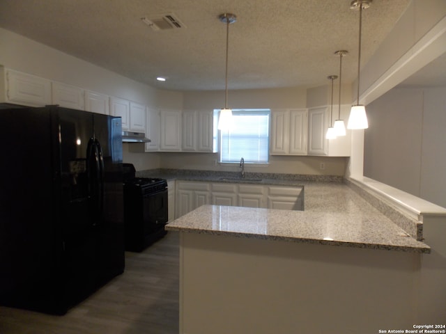 kitchen with black appliances, white cabinetry, dark hardwood / wood-style flooring, and kitchen peninsula