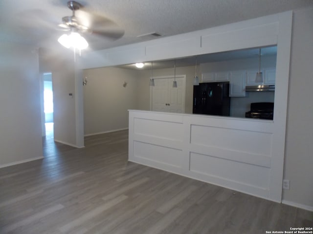 interior space featuring a textured ceiling, ceiling fan, and hardwood / wood-style floors