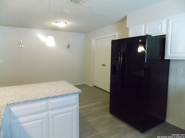 kitchen with a textured ceiling, black fridge with ice dispenser, white cabinets, and light hardwood / wood-style floors