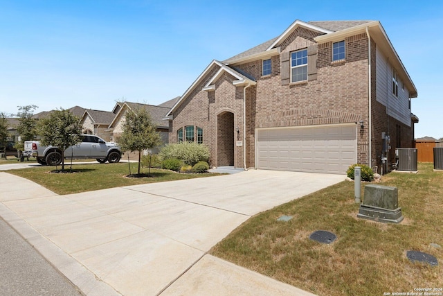 view of front of house with brick siding, driveway, a front lawn, and central air condition unit