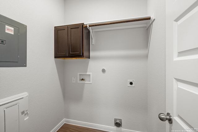 laundry area featuring hardwood / wood-style floors, electric panel, hookup for a washing machine, cabinets, and electric dryer hookup