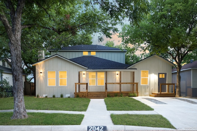 view of front of property with a lawn and a porch