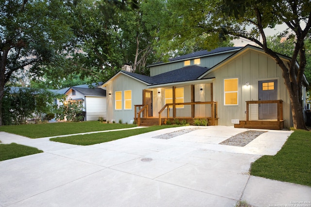 view of front of home with a porch and a front yard