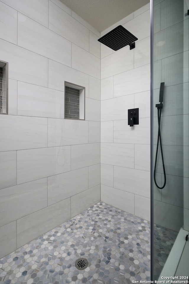 bathroom with a tile shower