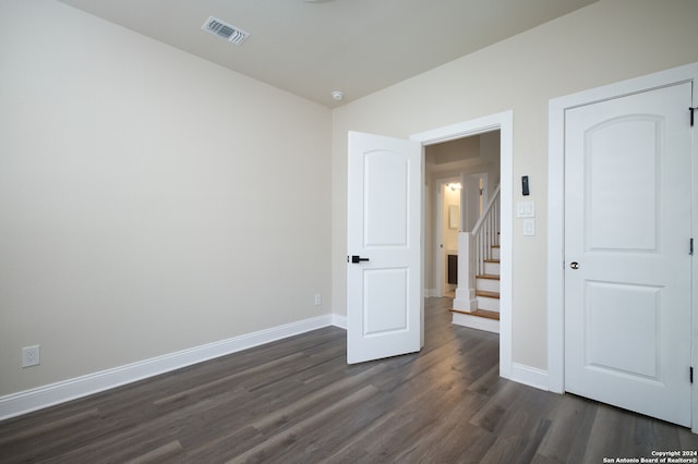 unfurnished bedroom featuring dark hardwood / wood-style flooring