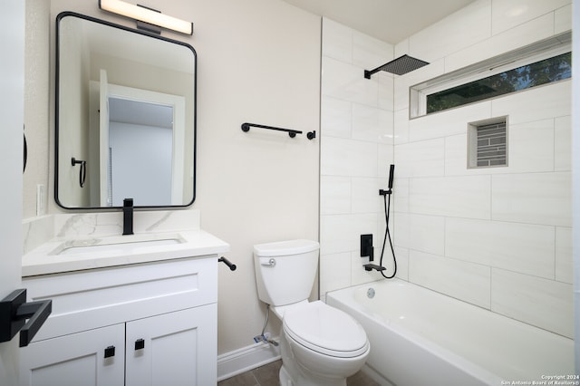 full bathroom featuring tile patterned flooring, tiled shower / bath, toilet, and vanity