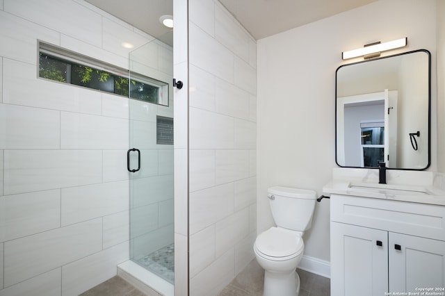 bathroom featuring tile patterned flooring, an enclosed shower, vanity, and toilet