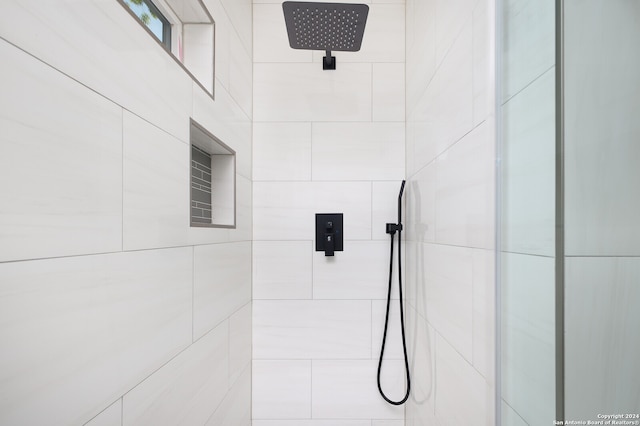 bathroom with tiled shower