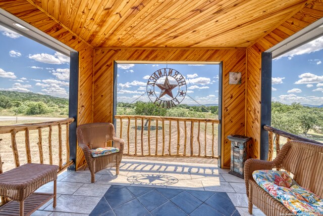 sunroom with a wealth of natural light and wooden ceiling