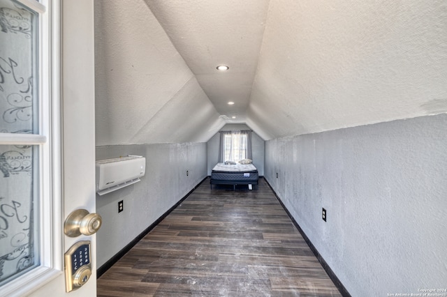 bonus room with a textured ceiling, lofted ceiling, and dark hardwood / wood-style flooring