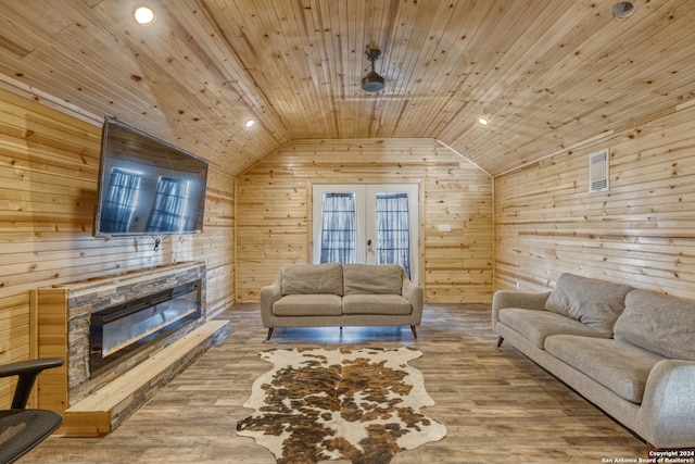 living room with hardwood / wood-style floors, a fireplace, french doors, wood ceiling, and lofted ceiling