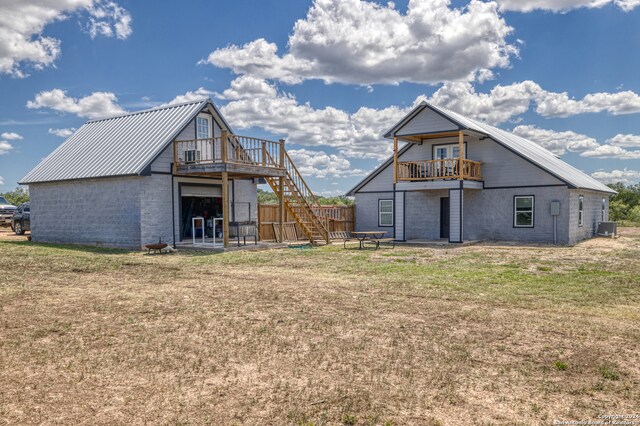 back of house featuring a deck and a yard