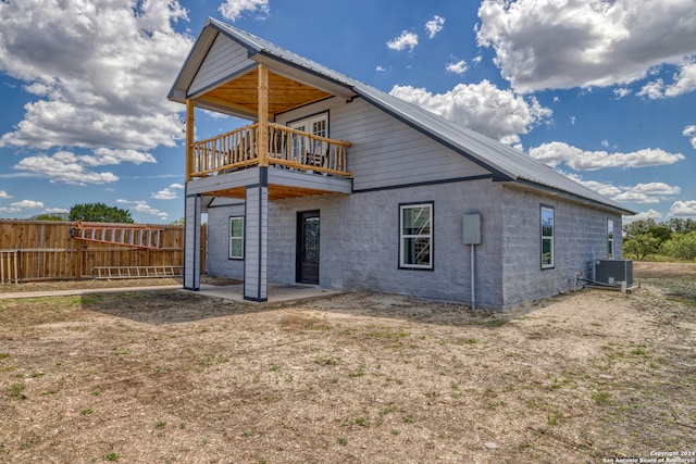 rear view of property featuring central AC