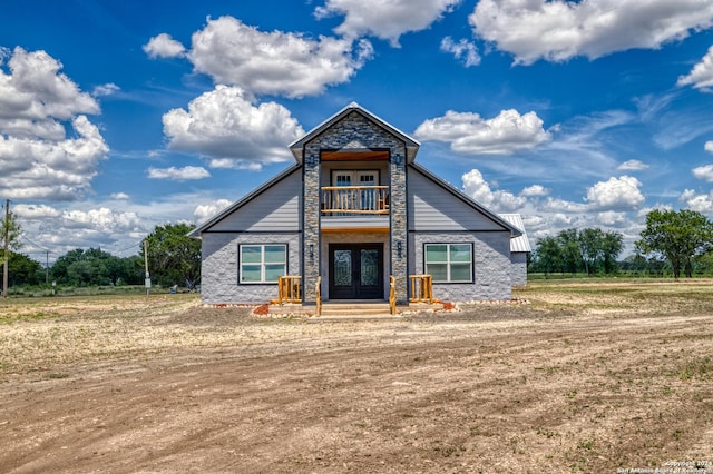 136 Cardinal Dr, Camp Wood, TX 78833 - view of front of home with a balcony, french doors, and stone siding