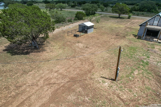 birds eye view of property with a rural view