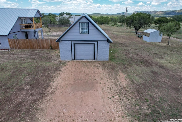 136 Cardinal Dr, Camp Wood, TX 78833 - garage with driveway, fence, and a mountain view