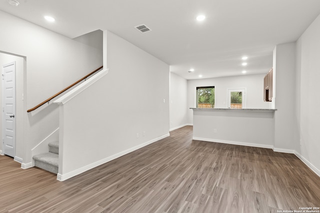 unfurnished living room with wood-type flooring