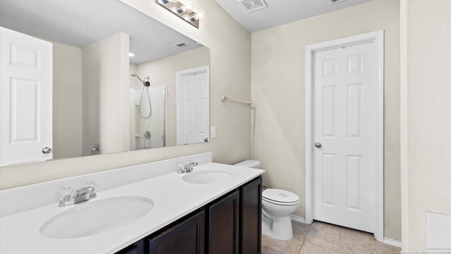 bathroom with toilet, visible vents, walk in shower, and a sink