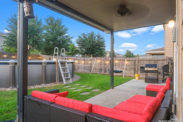 view of patio featuring a fenced backyard, ceiling fan, and an outdoor living space