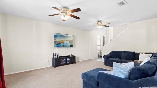 living room with carpet, visible vents, and ceiling fan