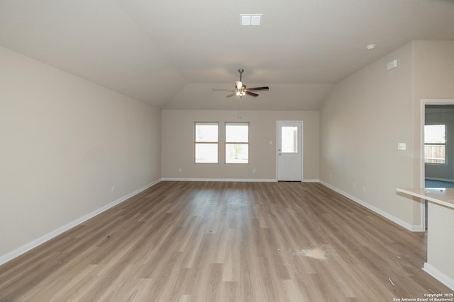 unfurnished living room with ceiling fan, vaulted ceiling, and light wood-type flooring