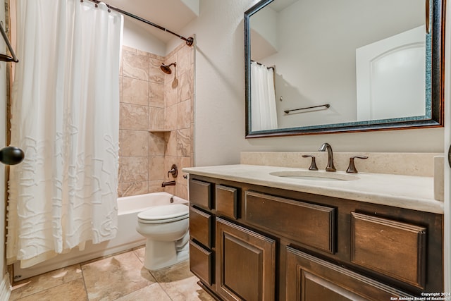 full bathroom with tile patterned floors, shower / bath combination with curtain, vanity, and toilet