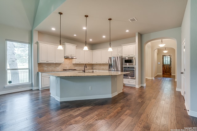 kitchen featuring white cabinetry, appliances with stainless steel finishes, dark wood-type flooring, and a healthy amount of sunlight