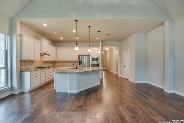 kitchen featuring white cabinets, tasteful backsplash, appliances with stainless steel finishes, and dark wood-type flooring