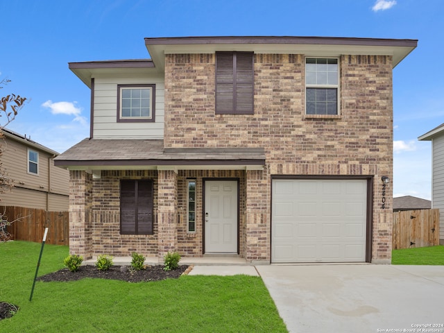 view of front facade with a garage and a front lawn