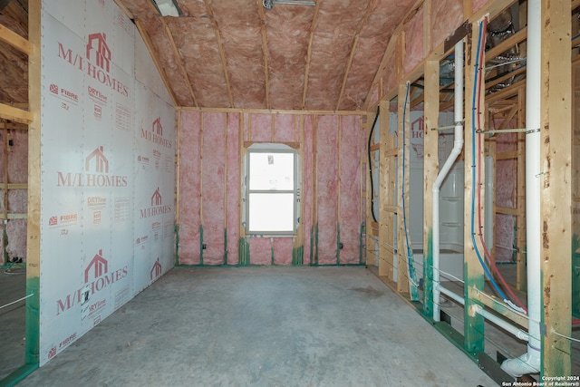 misc room featuring lofted ceiling and concrete floors