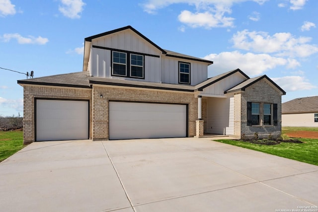 view of front facade featuring board and batten siding, concrete driveway, brick siding, and a garage