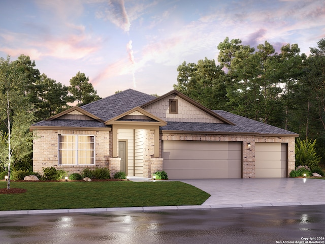 craftsman-style house featuring a garage and a yard