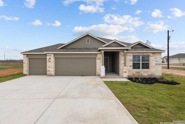 view of front facade with an attached garage, a shingled roof, driveway, stone siding, and a front yard